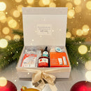 Open gift box with products on a dark surface