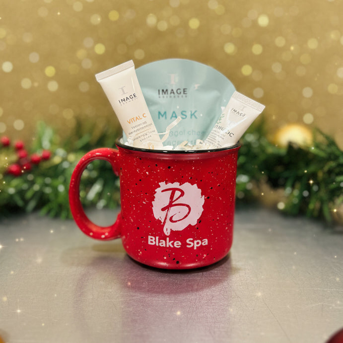 Red cup-shaped container with a skincare product on a dark surface